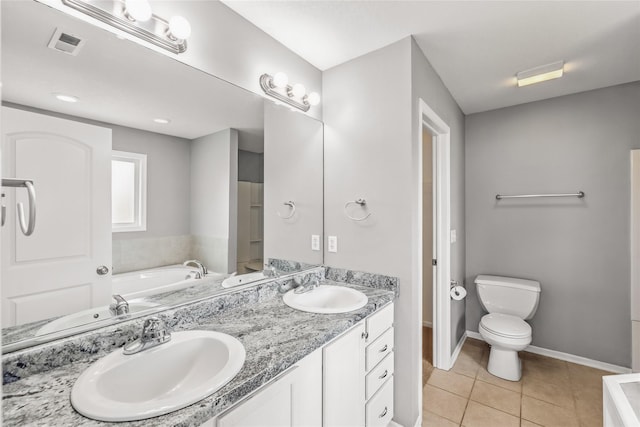 904 SE Little Beaver Dr, Grimes, IA 50111 - full bath featuring a garden tub, double vanity, tile patterned flooring, toilet, and baseboards
