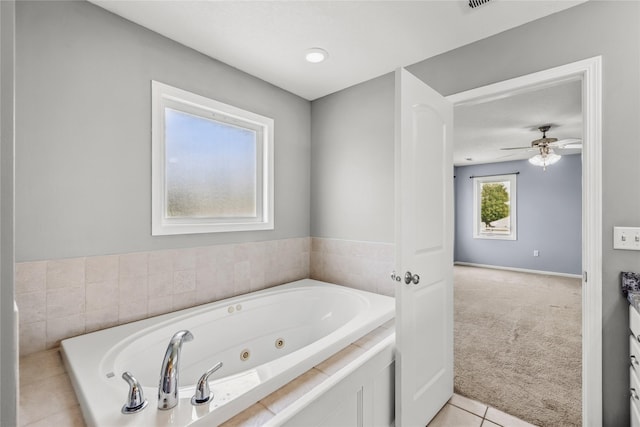 904 SE Little Beaver Dr, Grimes, IA 50111 - full bath with a tub with jets, a ceiling fan, and tile patterned floors
