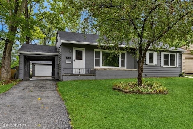 6445 Center St, Windsor Heights, IA 50324 - ranch-style home featuring a front lawn, asphalt driveway, an attached garage, and brick siding