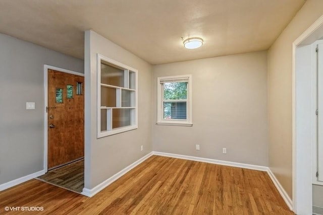 6445 Center St, Windsor Heights, IA 50324 - empty room with wood finished floors and baseboards