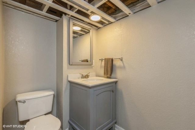 6445 Center St, Windsor Heights, IA 50324 - bathroom featuring toilet, vanity, and a textured wall