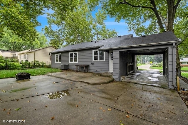 6445 Center St, Windsor Heights, IA 50324 - rear view of house with a fire pit, a patio area, and driveway