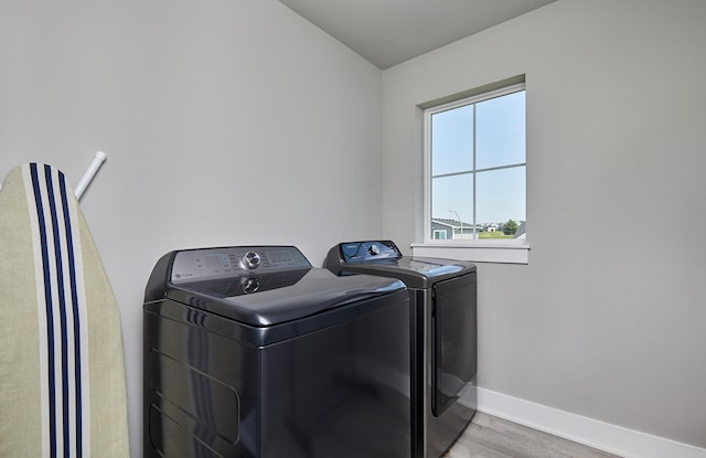 2930 Kestrel St, Norwalk, IA 50211 - laundry area featuring washing machine and clothes dryer and wood finished floors