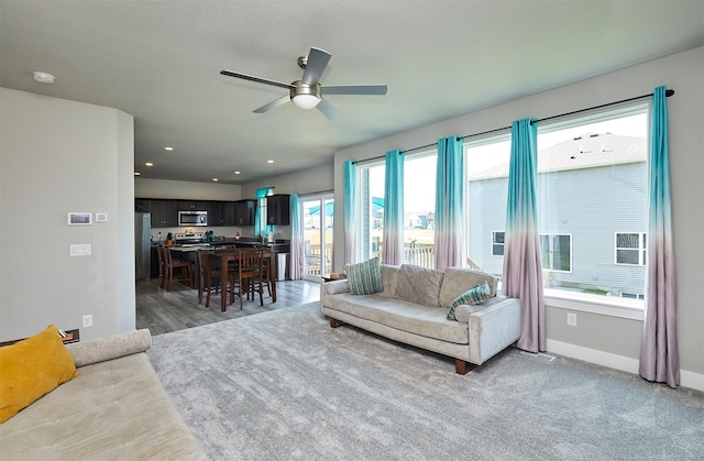 2930 Kestrel St, Norwalk, IA 50211 - living room featuring ceiling fan and baseboards