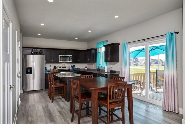 2930 Kestrel St, Norwalk, IA 50211 - kitchen with stainless steel appliances, light wood-style flooring, recessed lighting, and a kitchen island