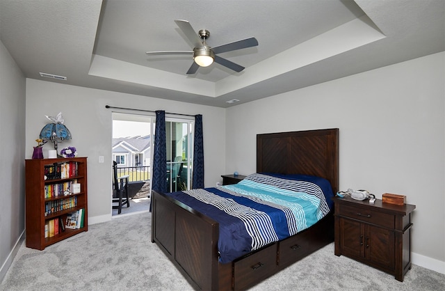 2930 Kestrel St, Norwalk, IA 50211 - bedroom featuring a tray ceiling, light carpet, access to outside, and a ceiling fan