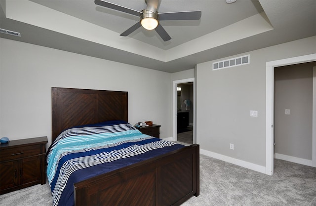 2930 Kestrel St, Norwalk, IA 50211 - bedroom featuring light colored carpet, a raised ceiling, a ceiling fan, and connected bathroom