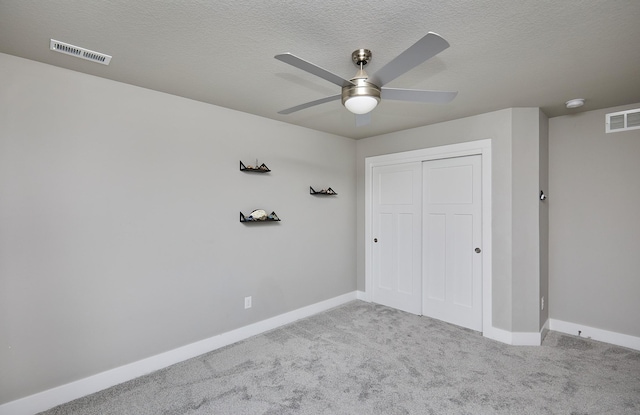 2930 Kestrel St, Norwalk, IA 50211 - unfurnished bedroom featuring carpet floors, a closet, a textured ceiling, and a ceiling fan