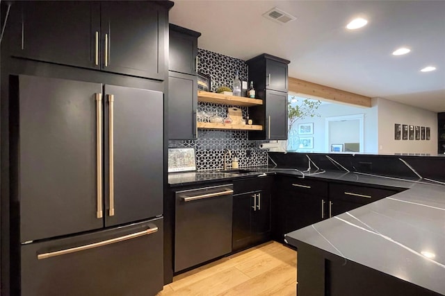 1000 NE 23rd St, Grimes, IA 50111 - kitchen featuring appliances with stainless steel finishes, light wood-type flooring, open shelves, recessed lighting, and decorative backsplash