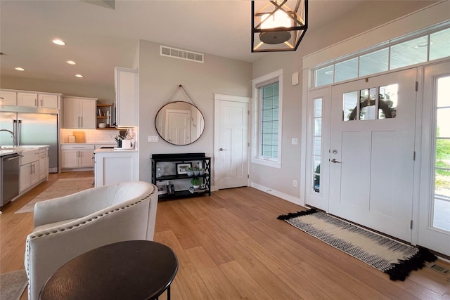 1000 NE 23rd St, Grimes, IA 50111 - foyer featuring light wood-type flooring, recessed lighting, and baseboards