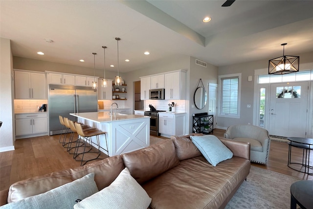 1000 NE 23rd St, Grimes, IA 50111 - living room featuring light wood-type flooring, recessed lighting, and baseboards