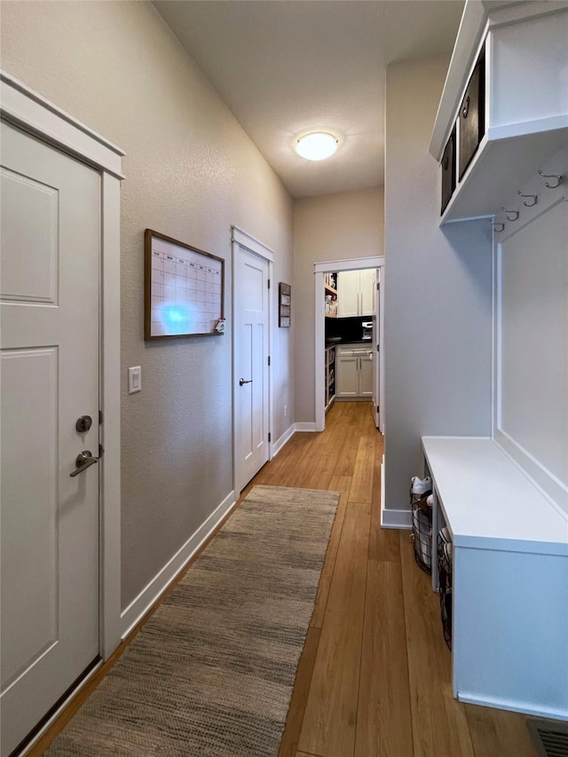 1000 NE 23rd St, Grimes, IA 50111 - mudroom with light wood-style floors and baseboards