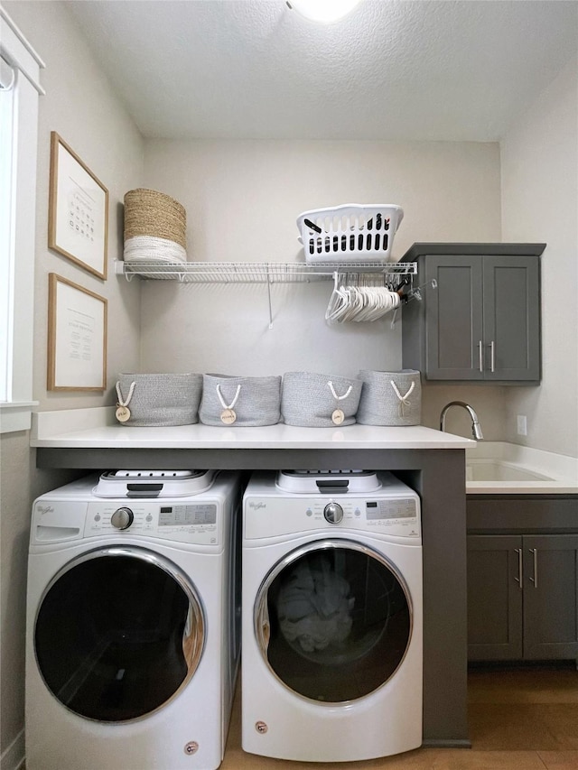 1000 NE 23rd St, Grimes, IA 50111 - laundry area featuring washer and dryer, cabinet space, and wood finished floors