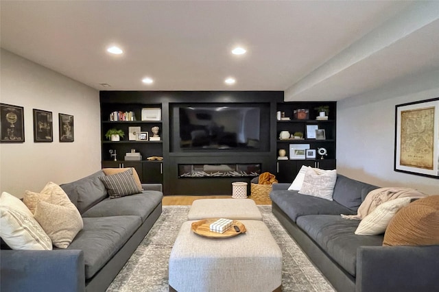 1000 NE 23rd St, Grimes, IA 50111 - living area featuring built in shelves, wood finished floors, and recessed lighting