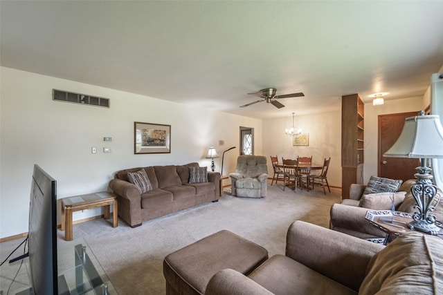530 Stuart St, Carlisle, IA 50047 - carpeted living room with a chandelier and a ceiling fan