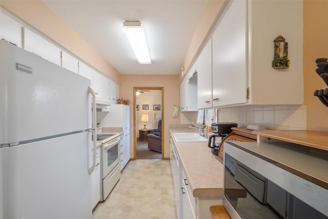 530 Stuart St, Carlisle, IA 50047 - kitchen with white appliances, a sink, white cabinets, light countertops, and decorative backsplash