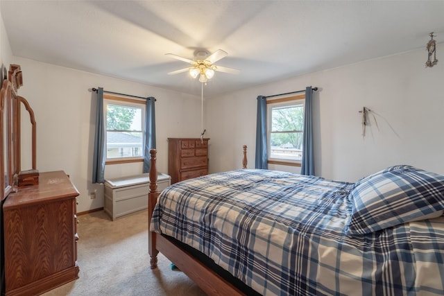530 Stuart St, Carlisle, IA 50047 - bedroom with multiple windows, light colored carpet, baseboards, and ceiling fan