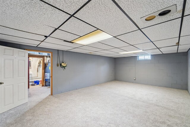530 Stuart St, Carlisle, IA 50047 - below grade area with water heater, carpet floors, concrete block wall, and a drop ceiling