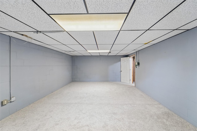 530 Stuart St, Carlisle, IA 50047 - finished below grade area featuring carpet, concrete block wall, and a drop ceiling