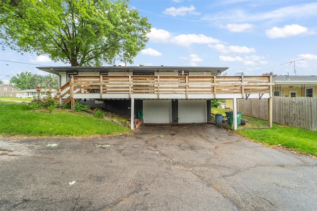 530 Stuart St, Carlisle, IA 50047 - exterior space with driveway, a garage, and a wooden deck