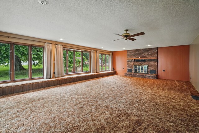 4500 100th St, Urbandale, IA 50322 - unfurnished living room with ceiling fan, carpet, a textured ceiling, a brick fireplace, and recessed lighting