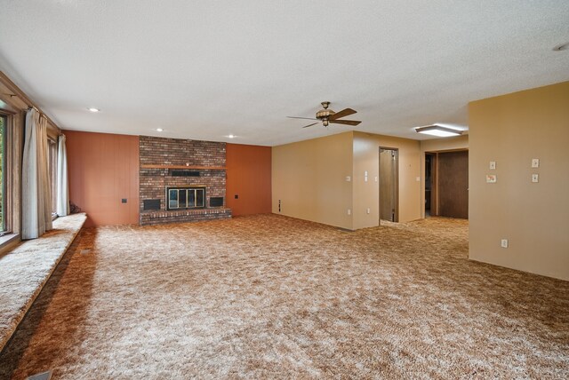 4500 100th St, Urbandale, IA 50322 - unfurnished living room with carpet, a fireplace, ceiling fan, and recessed lighting