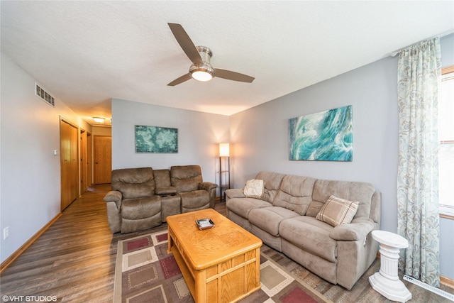 312 NE Harvey St, Grimes, IA 50111 - living room featuring wood finished floors, ceiling fan, baseboards, and healthy amount of natural light