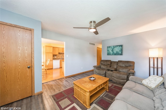 312 NE Harvey St, Grimes, IA 50111 - living room featuring ceiling fan, wood finished floors, and baseboards