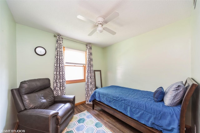 312 NE Harvey St, Grimes, IA 50111 - bedroom featuring wood finished floors, baseboards, and a ceiling fan