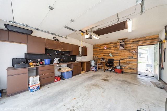 312 NE Harvey St, Grimes, IA 50111 - garage featuring a garage door opener and wooden walls