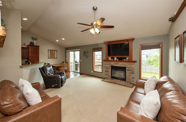 1324 Joshua Cir SE, Bondurant, IA 50035 - carpeted living room featuring vaulted ceiling, ceiling fan, plenty of natural light, recessed lighting, and a stone fireplace