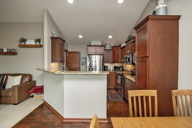 1324 Joshua Cir SE, Bondurant, IA 50035 - kitchen with appliances with stainless steel finishes, a peninsula, light stone counters, dark wood-style floors, and recessed lighting
