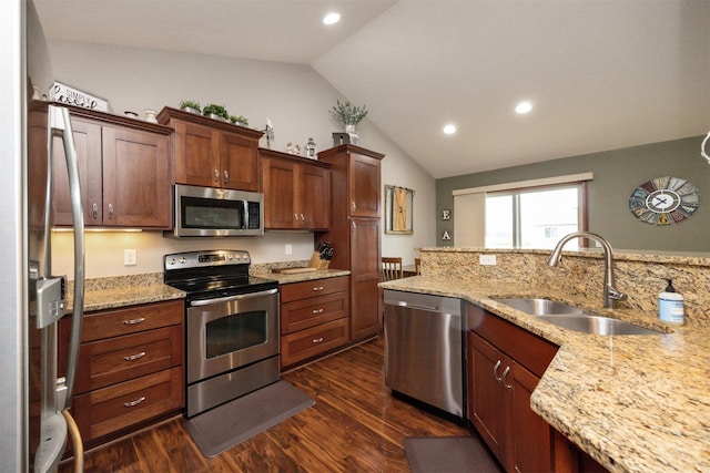 1324 Joshua Cir SE, Bondurant, IA 50035 - kitchen featuring stainless steel appliances, a sink, vaulted ceiling, dark wood-style flooring, and recessed lighting