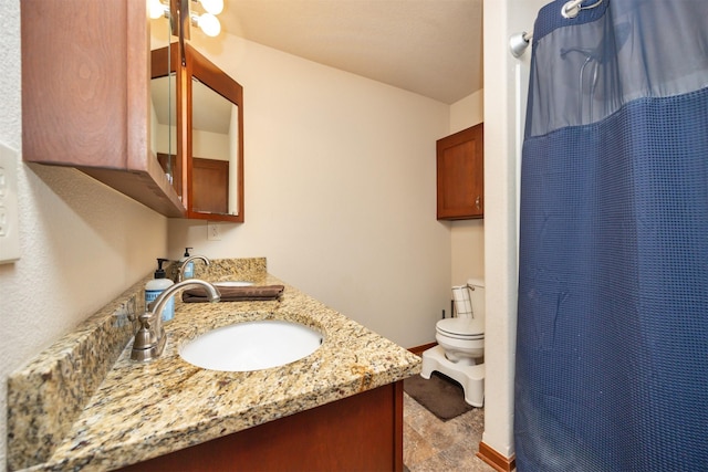 1324 Joshua Cir SE, Bondurant, IA 50035 - full bathroom featuring double vanity, toilet, stone finish flooring, baseboards, and a shower with curtain