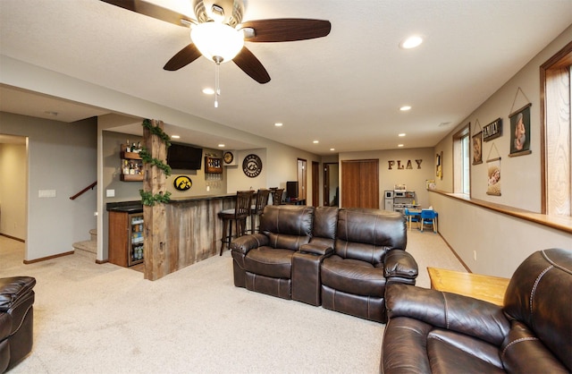 1324 Joshua Cir SE, Bondurant, IA 50035 - living area featuring light colored carpet, a bar, recessed lighting, stairs, and ceiling fan