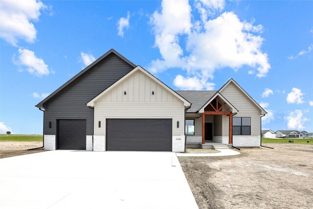 1201 Lakeview Cir NW, Bondurant, IA 50035 - modern farmhouse with an attached garage, board and batten siding, and concrete driveway