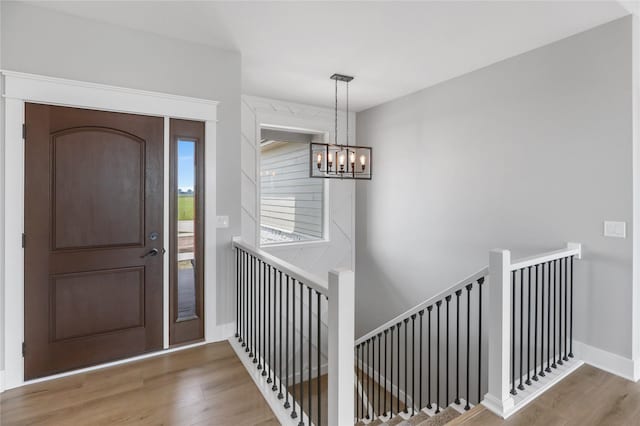 1201 Lakeview Cir NW, Bondurant, IA 50035 - entryway with a chandelier, wood finished floors, and baseboards