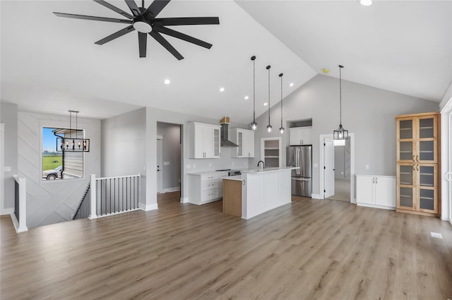 1201 Lakeview Cir NW, Bondurant, IA 50035 - unfurnished living room featuring high vaulted ceiling, a chandelier, light wood-style flooring, a ceiling fan, and recessed lighting