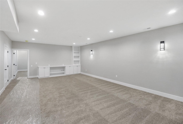 1201 Lakeview Cir NW, Bondurant, IA 50035 - basement with recessed lighting, baseboards, light carpet, and built in features
