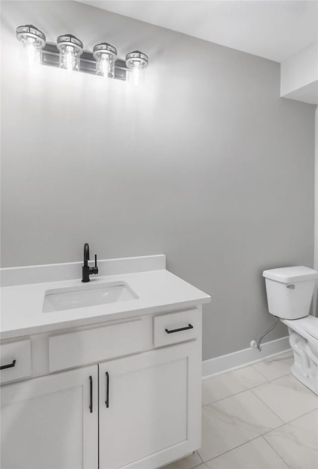 1201 Lakeview Cir NW, Bondurant, IA 50035 - bathroom featuring toilet, vanity, marble look tiles, and baseboards