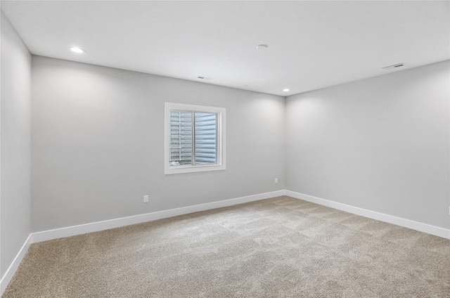 1201 Lakeview Cir NW, Bondurant, IA 50035 - spare room featuring baseboards, light colored carpet, and recessed lighting