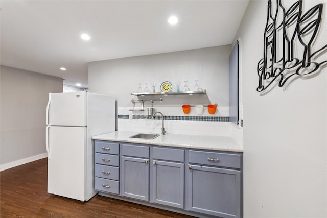 1822 30th Ave SW, Altoona, IA 50009 - kitchen with freestanding refrigerator, gray cabinets, a sink, dark wood-type flooring, and tasteful backsplash