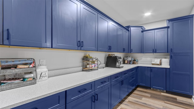 100 Coventry Ct, Clear Lake, IA 50428 - kitchen with blue cabinetry, light wood-type flooring, and recessed lighting