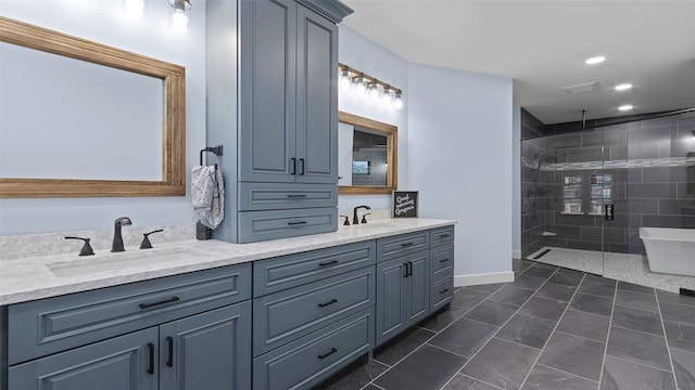 100 Coventry Ct, Clear Lake, IA 50428 - full bath featuring double vanity, a stall shower, a freestanding bath, baseboards, and recessed lighting