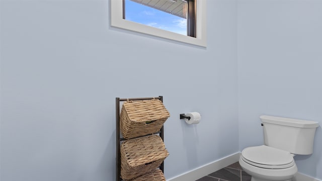 100 Coventry Ct, Clear Lake, IA 50428 - bathroom with baseboards, toilet, and tile patterned floors