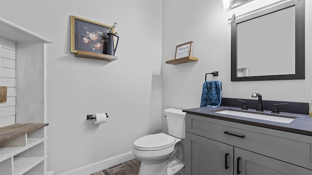 100 Coventry Ct, Clear Lake, IA 50428 - bathroom with toilet, vanity, and baseboards
