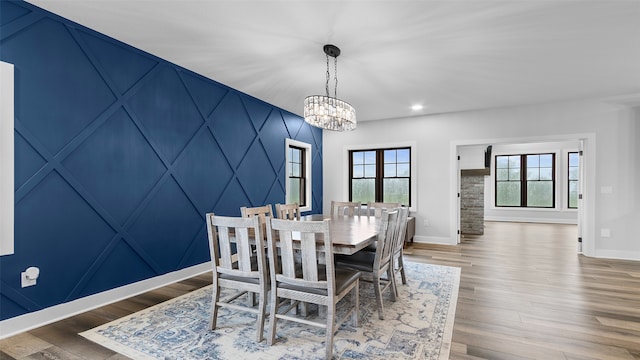 100 Coventry Ct, Clear Lake, IA 50428 - dining space with baseboards, a chandelier, healthy amount of natural light, recessed lighting, and wood finished floors