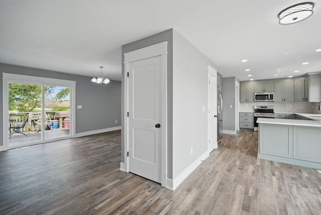 1026 44th Hwy, Guthrie Center, IA 50115 - kitchen featuring stainless steel appliances, gray cabinetry, baseboards, wood finished floors, and recessed lighting