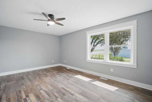 1026 44th Hwy, Guthrie Center, IA 50115 - unfurnished room featuring baseboards, a ceiling fan, and wood finished floors