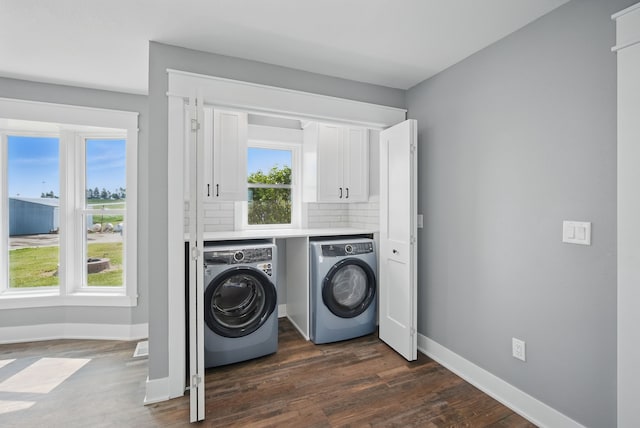 1026 44th Hwy, Guthrie Center, IA 50115 - washroom with washer and clothes dryer, baseboards, cabinet space, and dark wood-style floors